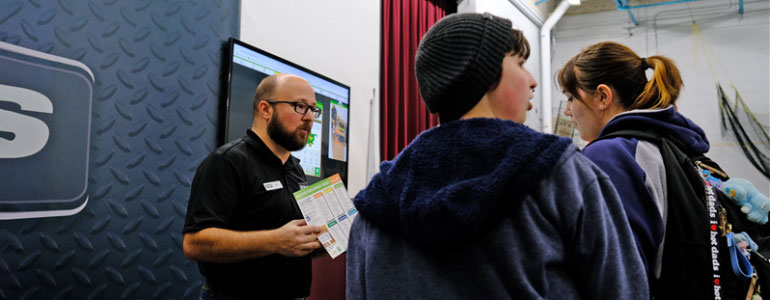 Two young adults visiting career booth