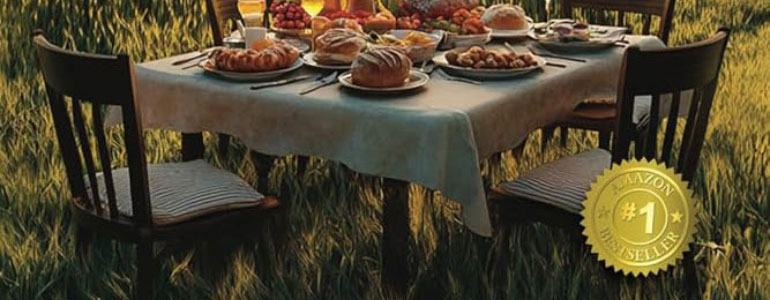 Set dinner table with food in middle of field