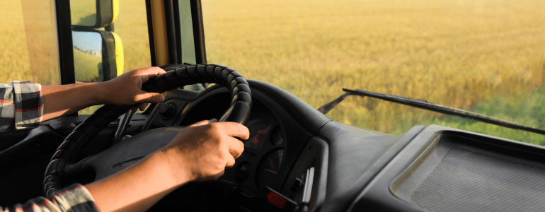 Man driving modern truck on sunny day, closeup